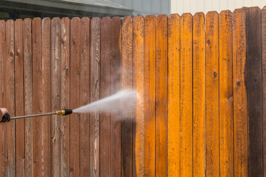 fence pressure washing service in progress